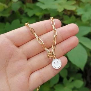 White smiley Necklace.